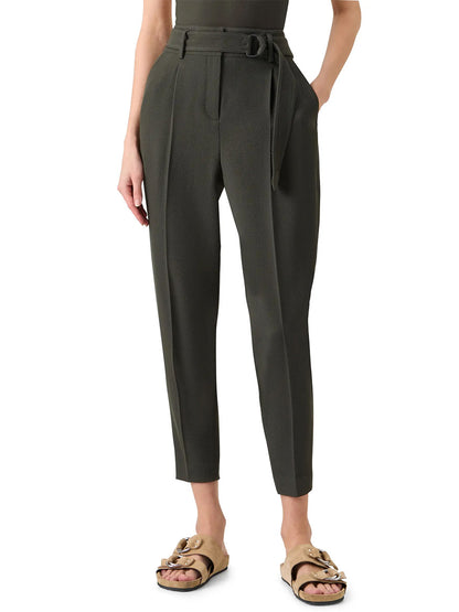 Wearing Akris Punto Fred Belted High Rise Ankle Pants in Olive with a tapered fit and belted waist, hands in pockets, styled with beige sandals.