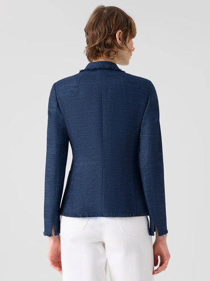 A person is seen from behind wearing the Akris Punto Fringed Indian Silk Double-Breasted Jacket in Blue with white pants, set against a plain light gray background.