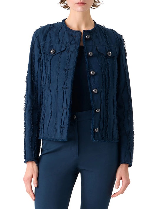 A person wearing the Akris Punto Fringed Wave Jacquard Jacket in Dark Blue, featuring frayed vertical stripes, button-front closure, chest flap pockets, reflective buttons, and matching navy pants.