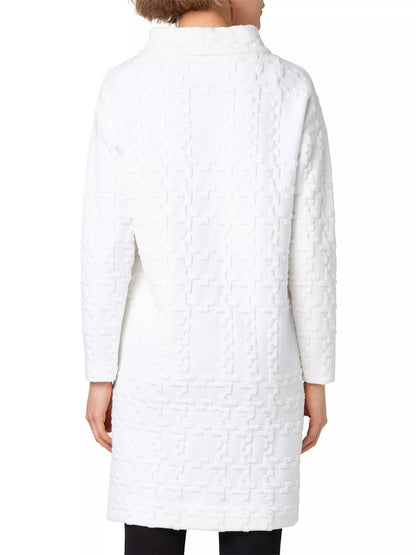 Back view of a person wearing the Akris Punto Glencheck 3D Jersey Oversize Dress in Cream, featuring an oversized fit and a raised geometric pattern with full-length sleeves, standing against a plain background.