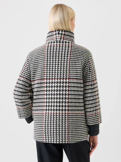 A person with blonde hair is seen from the back, wearing the Akris Punto Glencheck 2-in-1 Car Coat in Black/Cream/Vermillion.