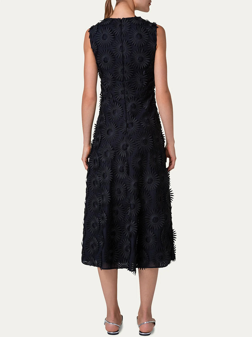 A woman from behind wearing the Akris Punto Hello Sunshine Embroidered Dress in Black, standing against a plain background.