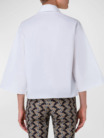 The back view of a woman wearing an Akris Punto Kimono Sleeve Blouse With Bird Applique in Cream.
