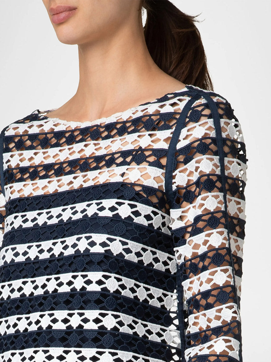 A person wearing the Akris Punto Kodak Stripe Dot Trumpet Sleeve Top in Cream/Navy with a boat neckline.