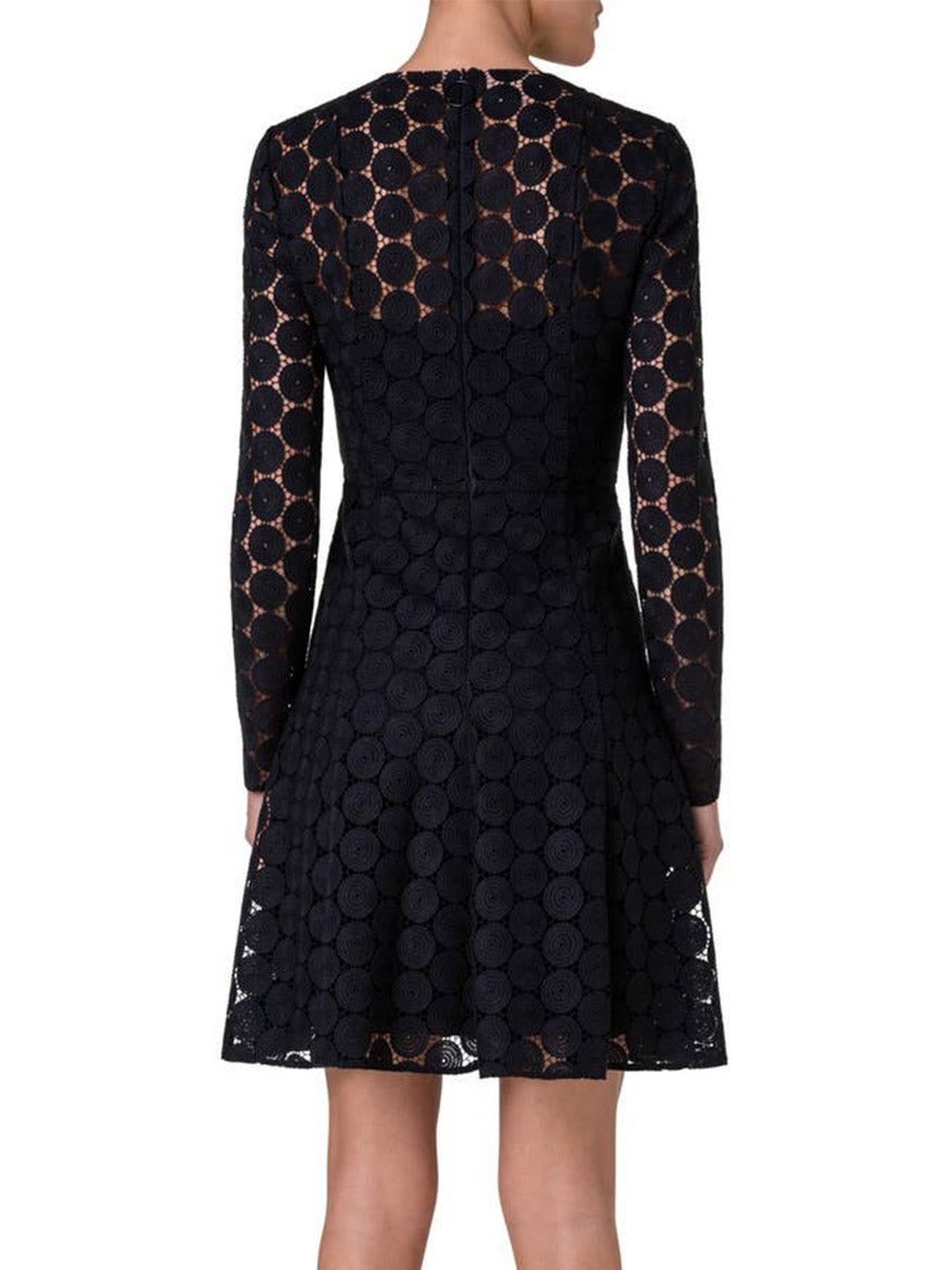 The back view of a woman wearing an Akris Punto Dot Long Sleeve Fit & Flare Lace Dress in Black.
