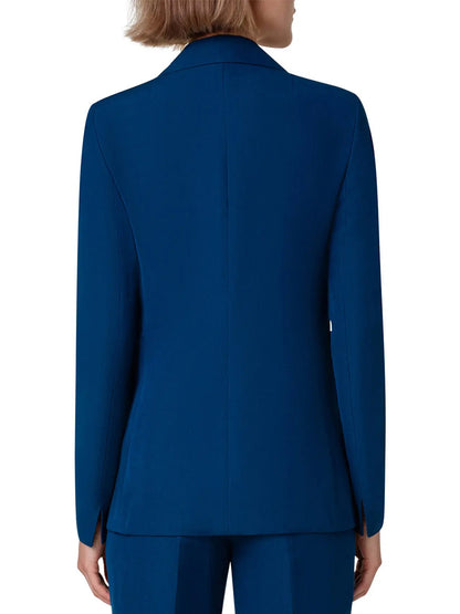 The back view of a woman in an Akris Punto Notched Lapel One-Button Blazer in Ink blue suit.