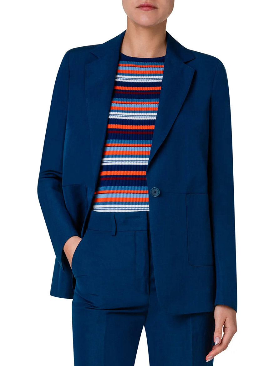 A woman wearing a blue Akris Punto Notched Lapel One-Button Blazer in Ink linen suit.