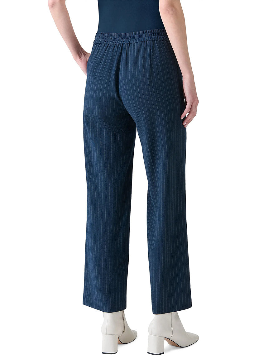 Person wearing Akris Punto Marlon Pinstripe Wide Leg Pant in Navy/Cream and white heeled ankle boots, shown from the back against a plain white background.