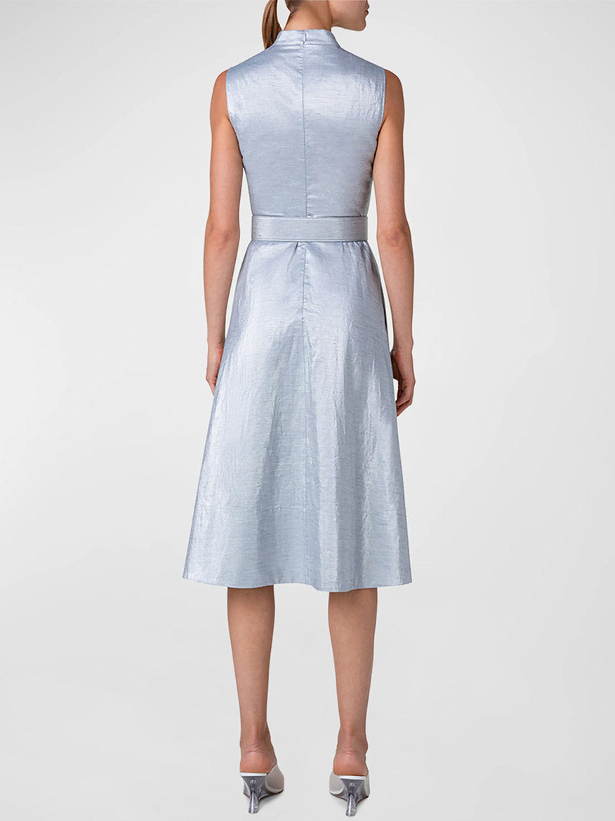 Woman standing in a Akris Punto Metallic Cotton Belted Midi Dress in Silver Blue, viewed from the back.