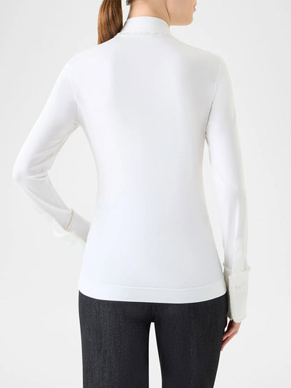 A person with a ponytail is shown from the back, wearing a fitted cream Akris Punto Mixed Media Fringed Button-Down Blouse and dark pants against a plain background.