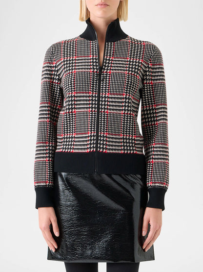 A woman wears the Akris Punto Mock Neck Plaid Cardigan in Black/Cream/Vermillion with a black vinyl skirt, photographed against a plain background.