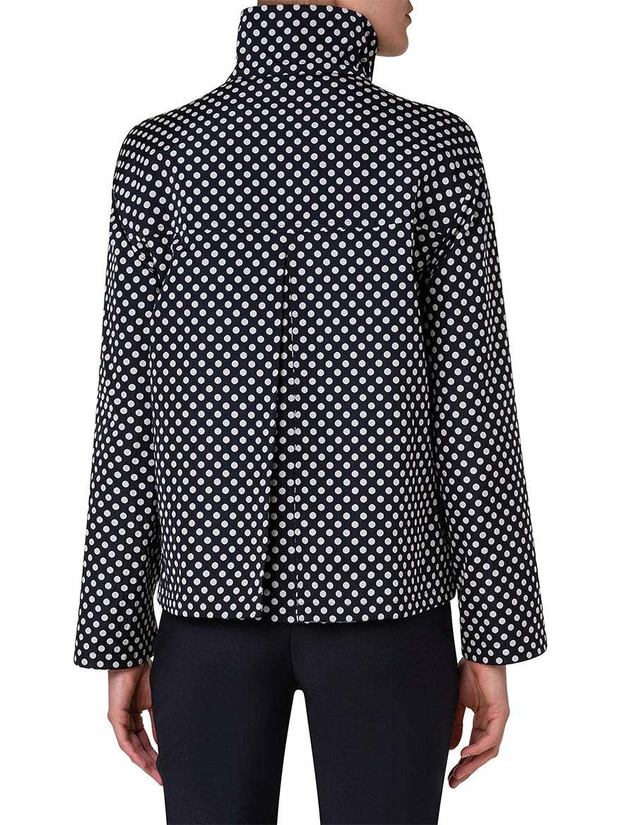A model shows off the Akris Punto Reversible Polka Dot Jacket in Black/Navy from the back, styled with black pants for a boxy silhouette.