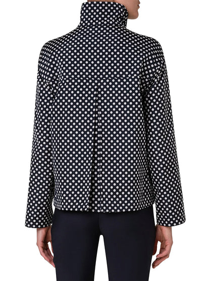 A model shows off the Akris Punto Reversible Polka Dot Jacket in Black/Navy from the back, styled with black pants for a boxy silhouette.