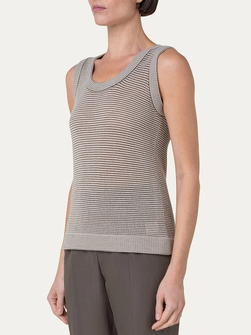 An elegant woman wearing an Akris Punto Ribbed Sleeveless Wool Knit Top in Nutmeg/Cream.