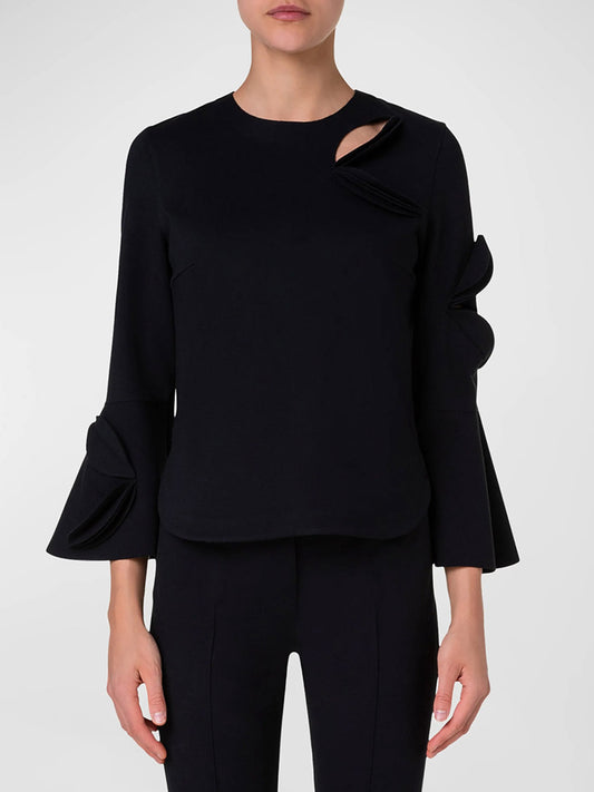 The woman is wearing an Akris Punto Cutout Blouse with Bird Applique in Black.