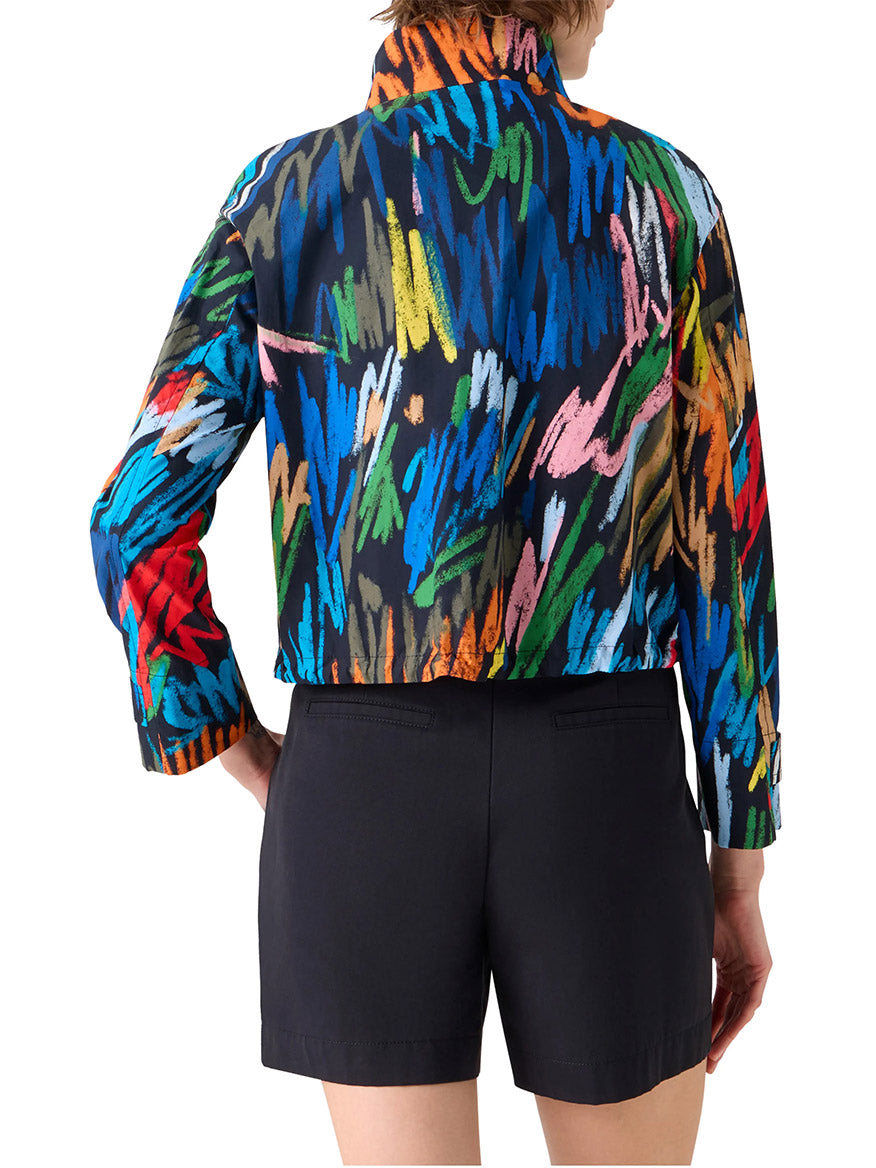 Person wears the Akris Punto Scribble Print Drawstring Jacket in Black Multi with black shorts, shown from the back against a white background.