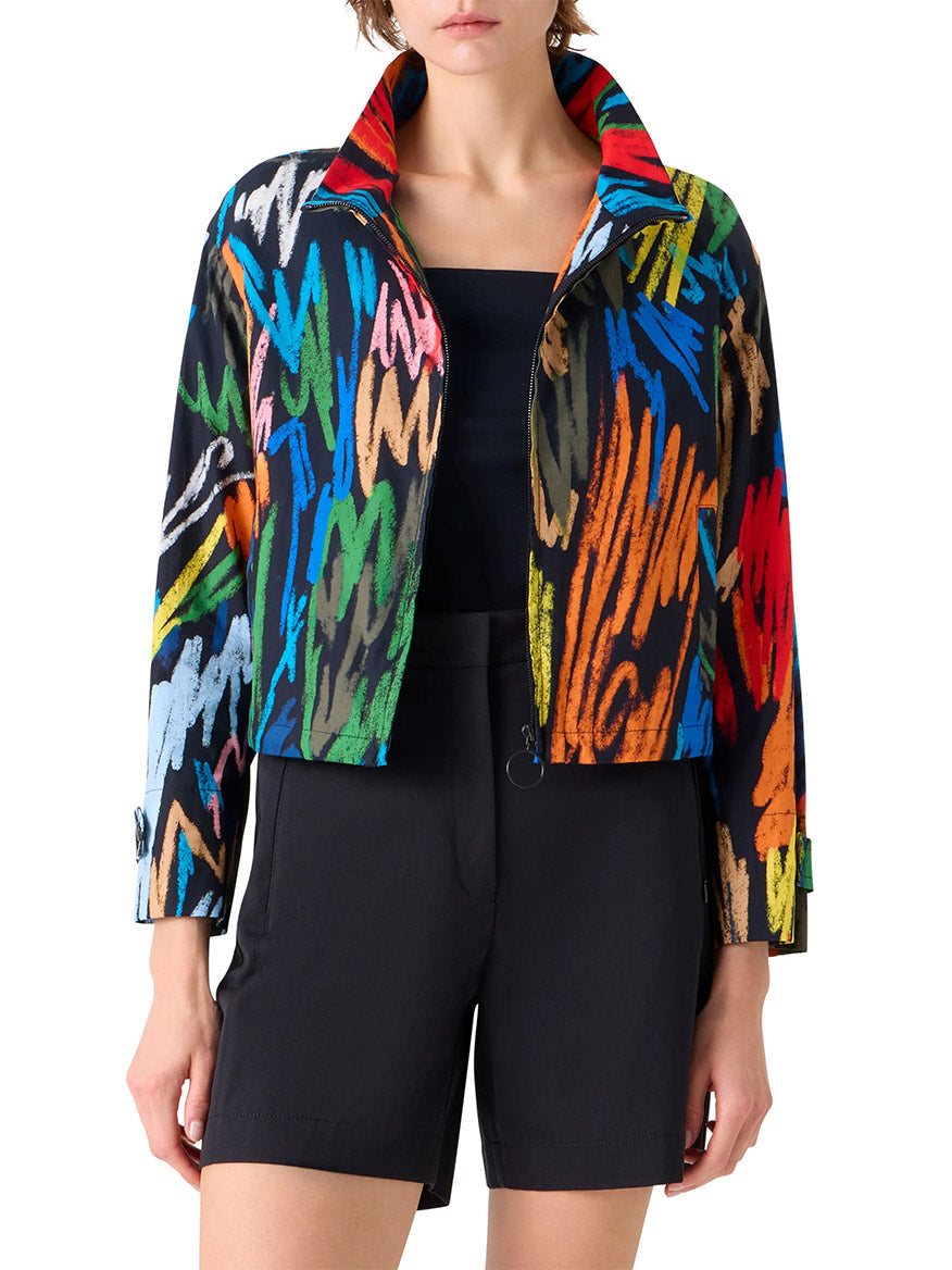 A person wearing the Akris Punto Scribble Print Drawstring Jacket in Black Multi over a black top and black shorts, standing facing forward with hands by their sides.