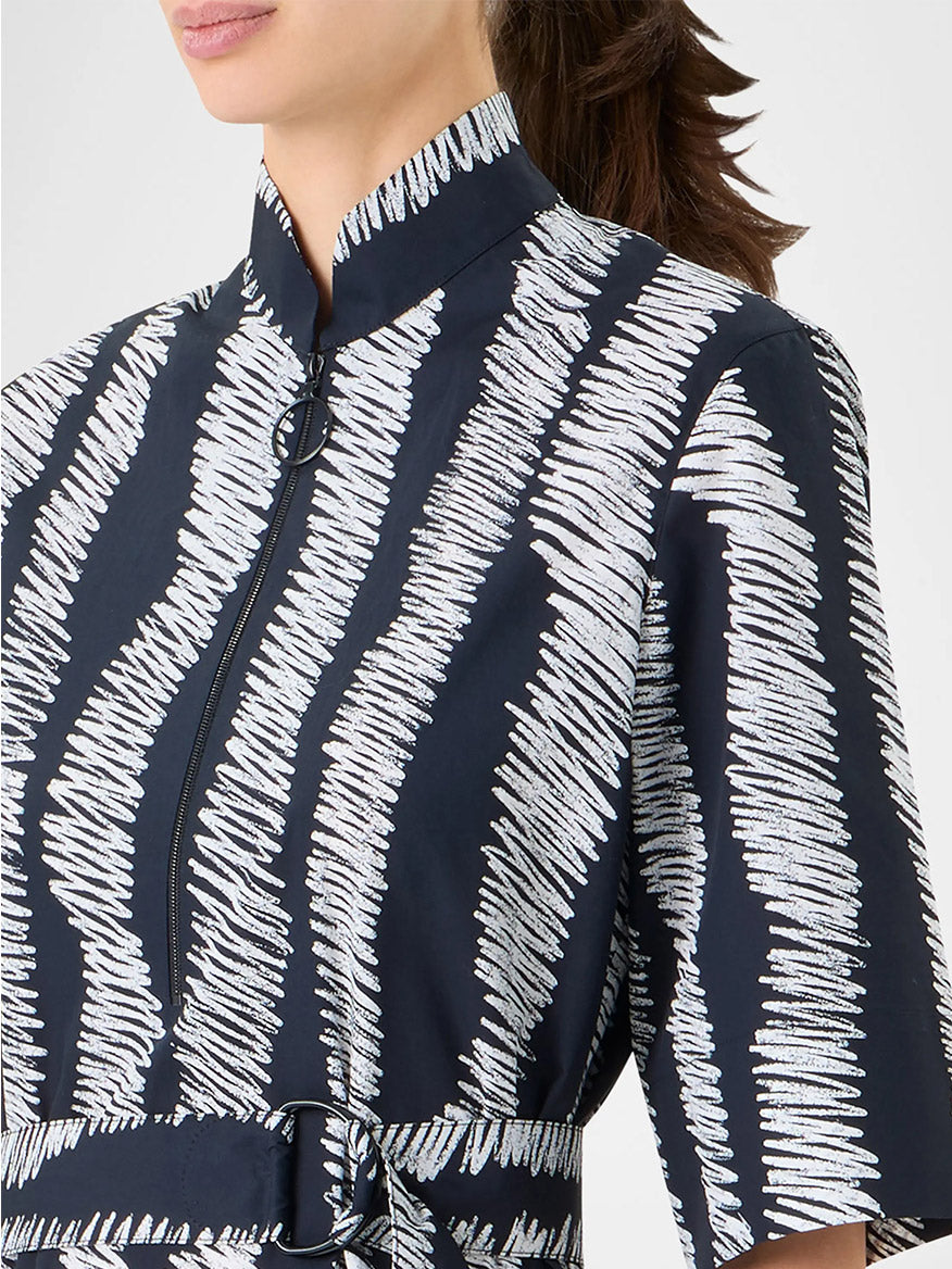 A woman wearing the Akris Punto Scribble Wave Shirt Dress in Black/Cream, featuring a high collar, short sleeves, and a front zipper.