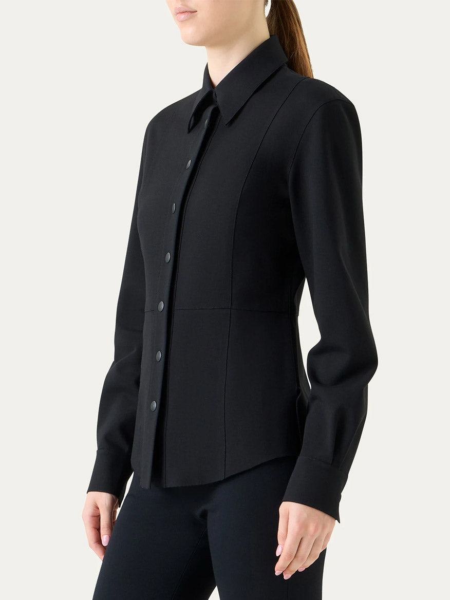 A person wears the Akris Punto Signature Viscose Jersey Slim Shirt in Black, styled with black pants, shown from the waist up against a plain background.