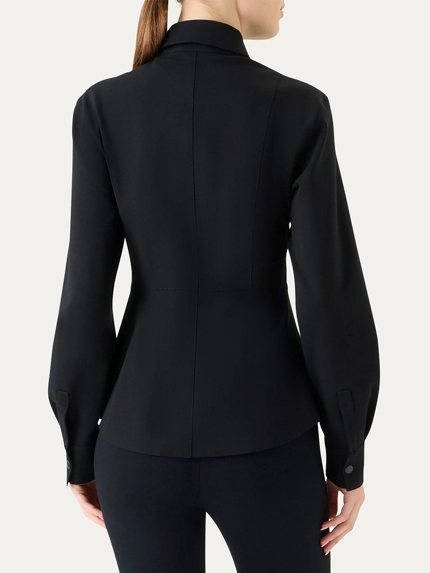 A person wearing the Akris Punto Signature Viscose Jersey Slim Shirt in Black, shown from the back, with tailored seams and buttoned cuffs.