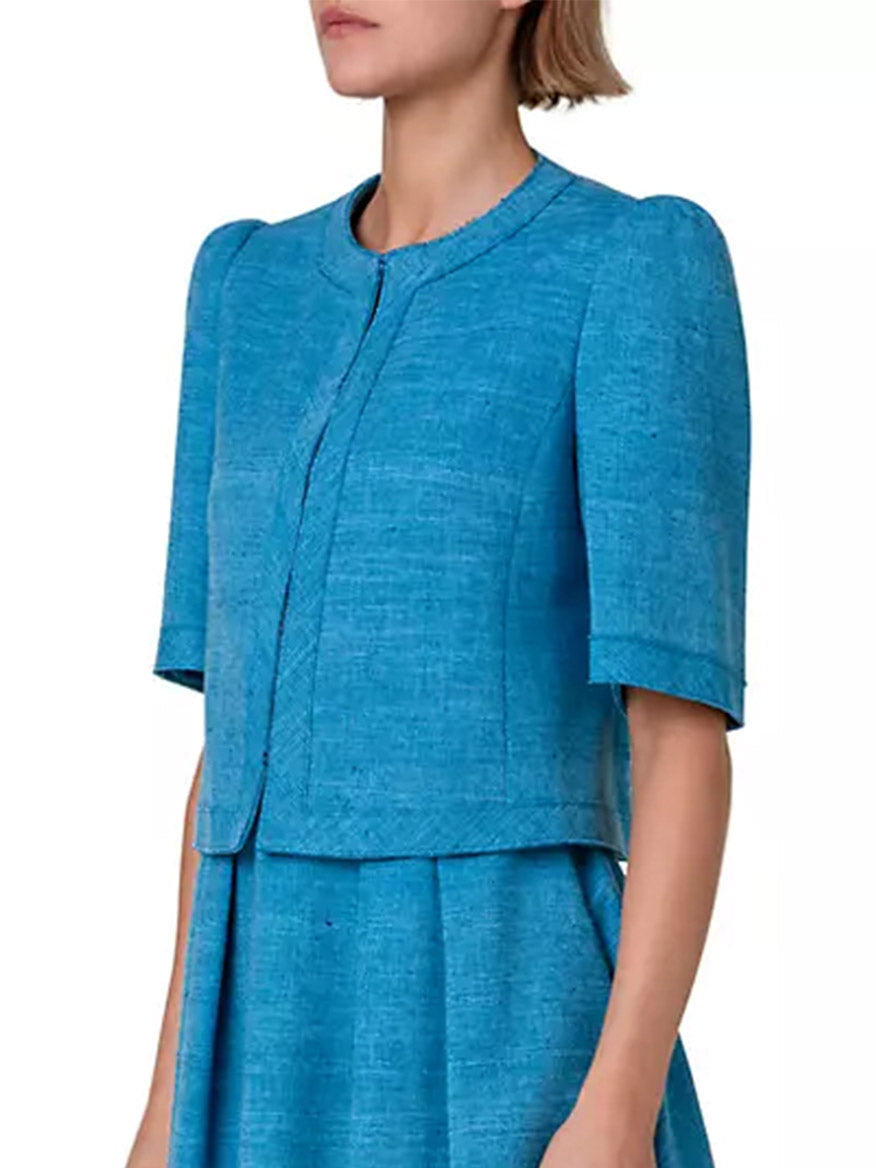 The model is wearing a tailored Akris Punto Short Sleeve Silk Blend Jacket in Medium Blue.