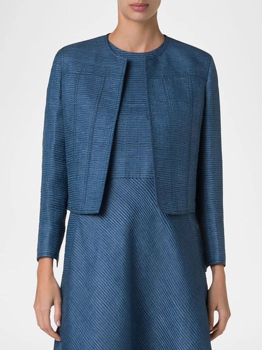 A person is wearing the Akris Punto Cropped Silk Ottoman Jacket in Medium Blue with a round neckline over a matching dress, shown from shoulders to mid-thigh.