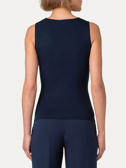 A person wearing an Akris Punto Square-Neck Jersey Tank Top in Ink and navy blue pants with signature dot detail is shown from the back.