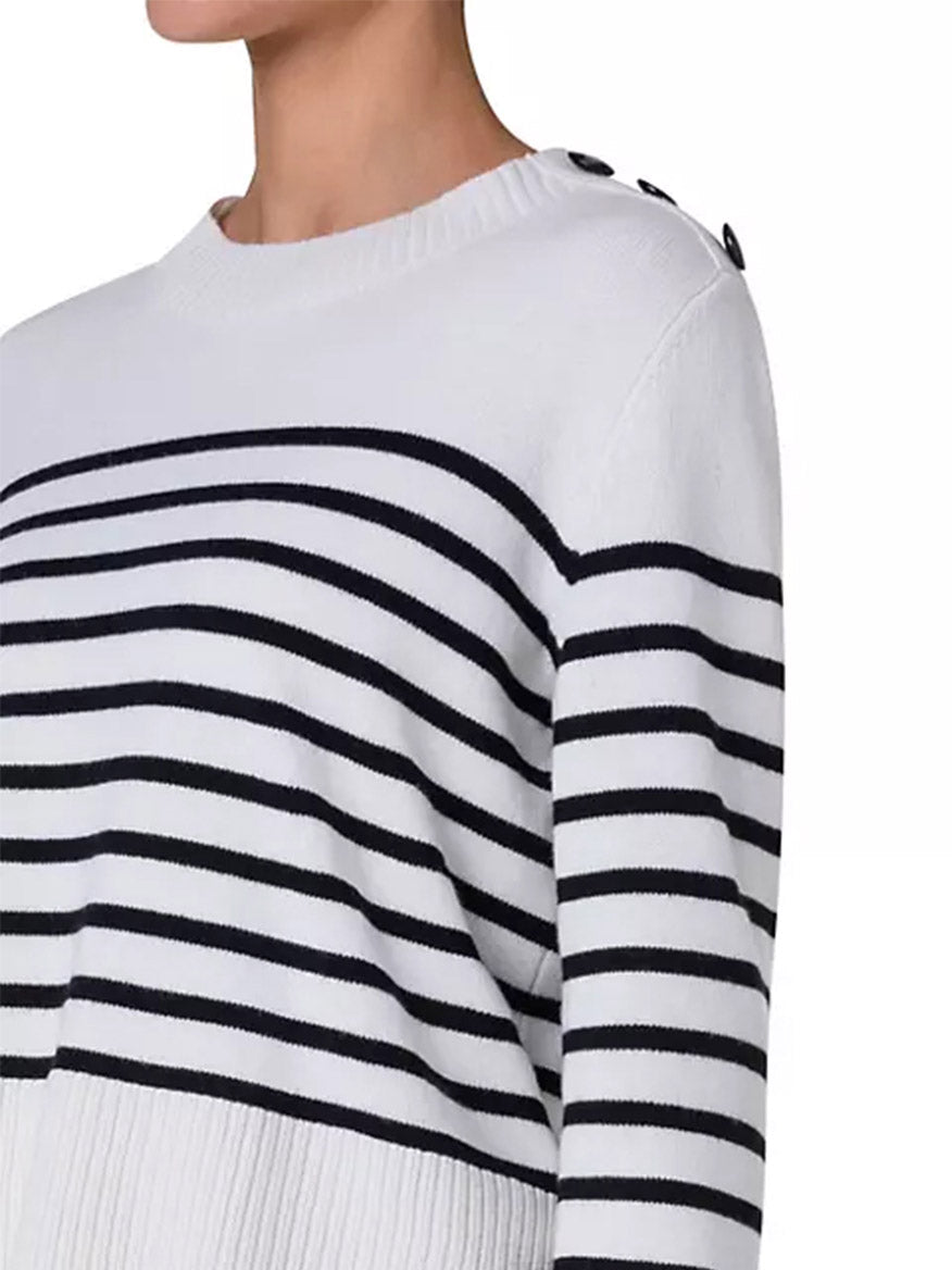 A woman wearing the Akris Punto Striped Crew Sweater With Snap Shoulder in Cream/Black made of virgin wool.