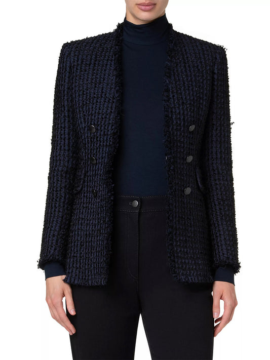 A person is wearing an Akris Punto Chunky Tweed Double-Breasted Jacket with Fringe in Navy over a black turtleneck and black pants. The blazer features a double-breasted design with four buttons. The person's face is not visible.