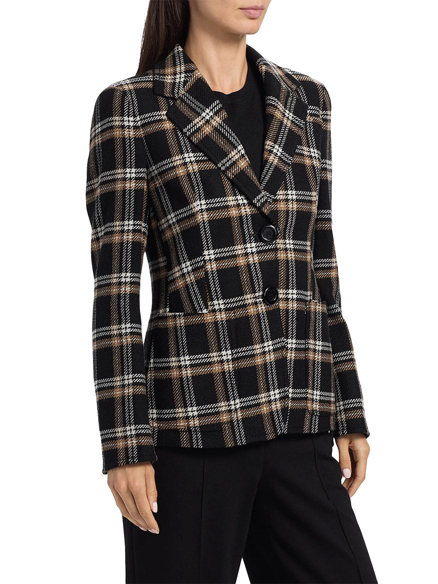 A woman wears an Akris Punto Tweed Plaid Structured Blazer in Black/Camel/Cream over a black top and black pants, shown from the waist up.