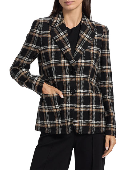 A woman wears the Akris Punto Tweed Plaid Structured Blazer in Black/Camel/Cream with black trousers and a black top, standing with one hand in her pocket.
