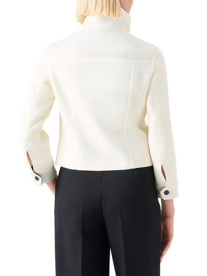 A person is shown from the back wearing an Akris Punto Wool Tricotine Stand Collar Jacket in Cream/Black with black trousers.
