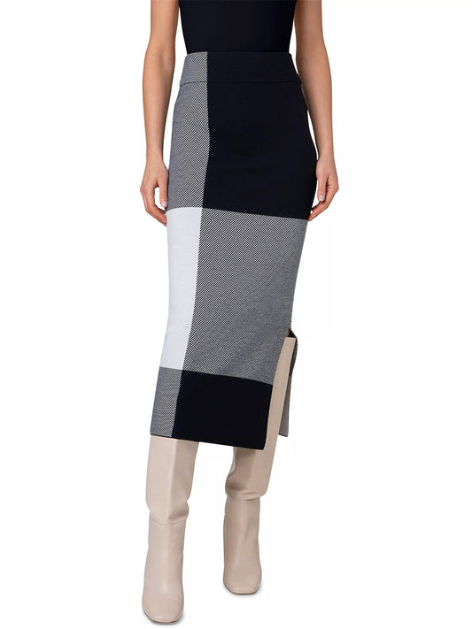 A person wearing a black top, an Akris Punto XL Gingham Merino Wool Midi Skirt in Navy/Cream with an elastic waistband, and beige boots.