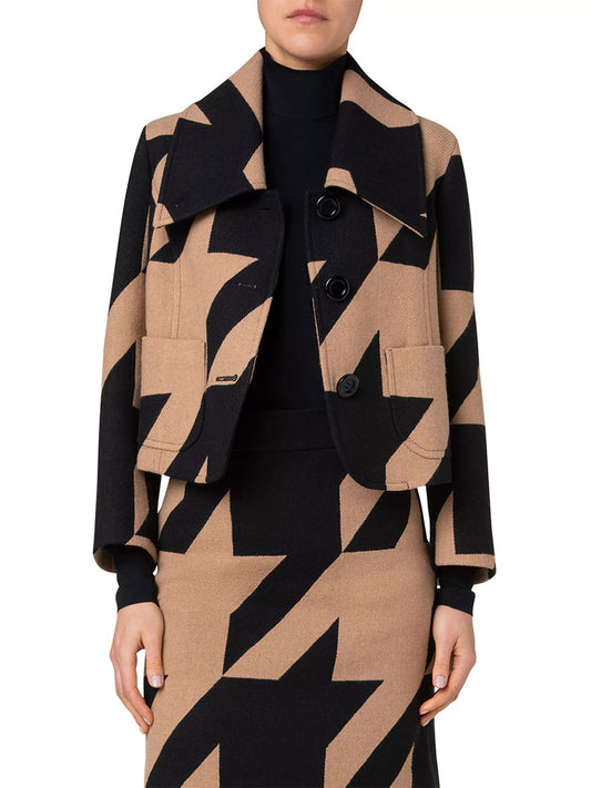 A person wearing the Akris Punto XL Houndstooth Boxy Jacquard Jacket in Black/Caramel, paired with a matching skirt, standing against a plain white background.