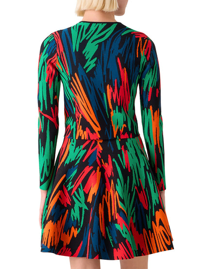 A person with short blond hair is shown from the back wearing the Akris Punto Scribble Jacquard Cardigan in Black Multi, which features a bright, crayon-scribbled print.