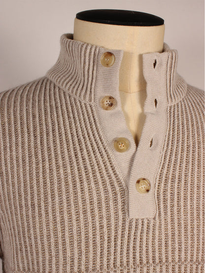 A close-up of the Maurizio Baldassari 4-Button Mock Neck Vanisé Stitch Sweater in Shade, featuring a ribbed high collar and four tan buttons on the front placket, displayed on a mannequin.