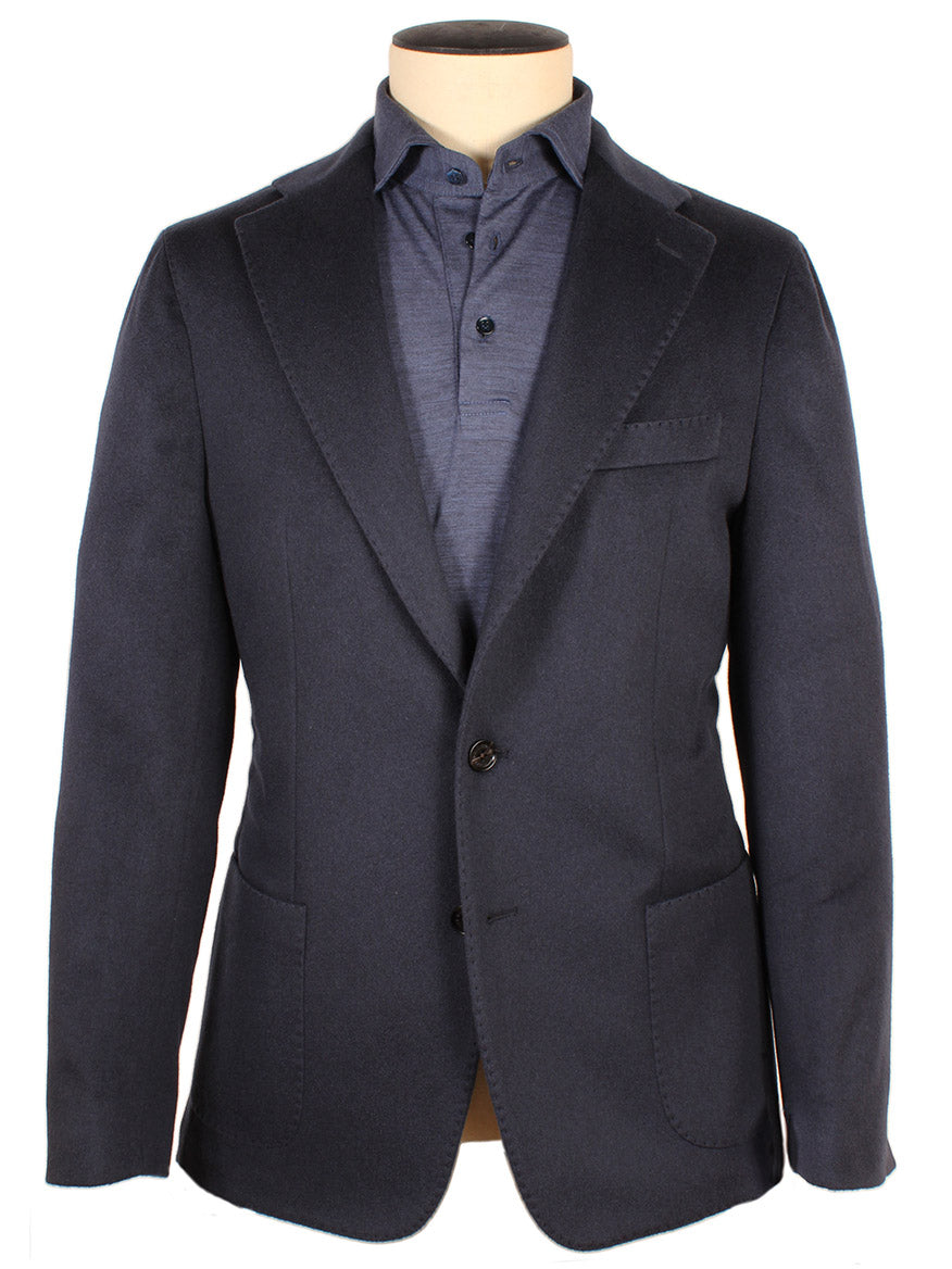 A dark blue Maurizio Baldassari Soft 2-Button Blazer is displayed on a mannequin, paired with a matching blue shirt. This stylish blazer, made in Italy, radiates quality and elegance.