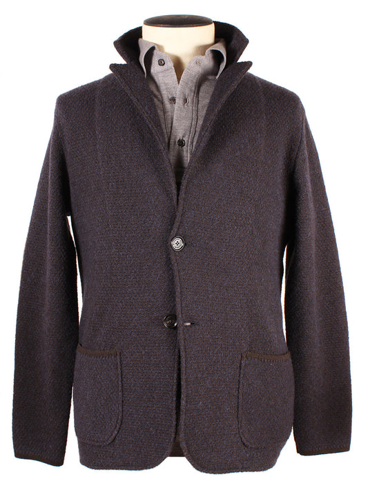 A grey wool blazer with a 2-button closure over a grey shirt on a mannequin. The Italian-made blazer features a notched collar and two front pockets, perfect for pairing with your Maurizio Baldassari Winter Pave Stitch Swacket in Navy/Brown.