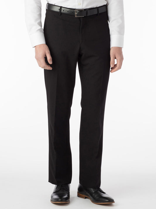 A person wearing Ballin Soho Comfort 'EZE' Commuter Bi-Stretch Gabardine Modern Flat Front Pants in black, a white long-sleeve shirt, black belt, and black dress shoes stands against a plain white background.