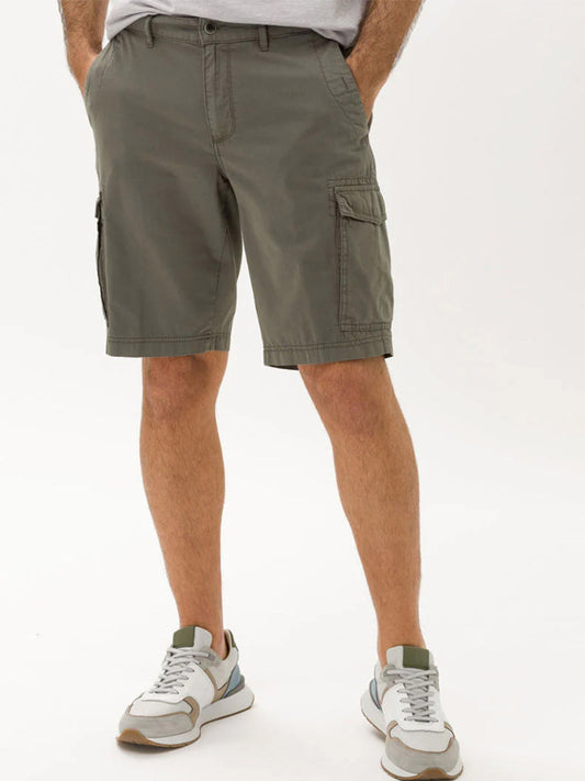 Man wearing Brax Brazil Cargo Shorts in Khaki and white sneakers.