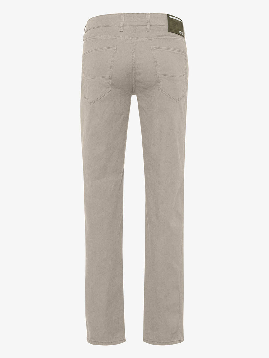 Back view of a pair of beige Brax Cadiz L Linen Flex pants in Cosy Linen five-pocket trousers on a white background.