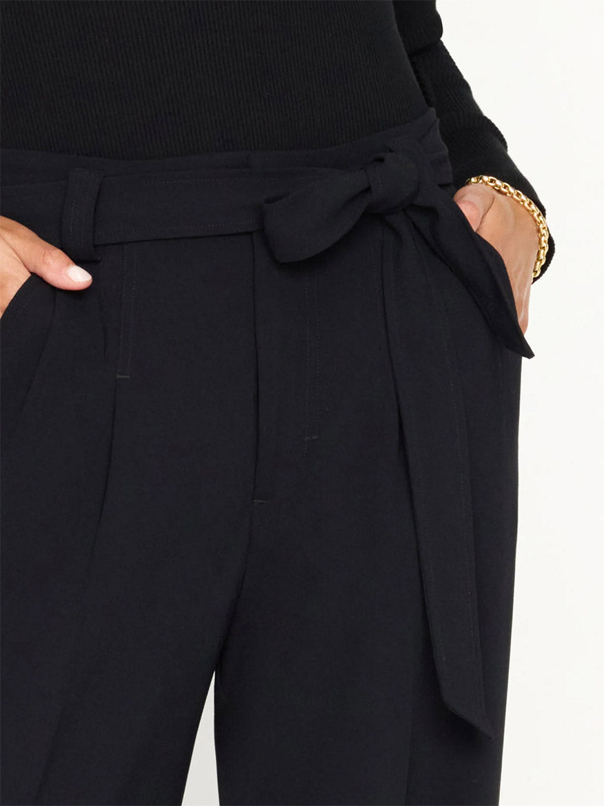 Close-up of a person wearing black Brochu Walker Duke Pant with a tied belt at the waist, highlighting the belt detail and fabric texture.