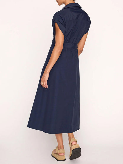 Woman in a Brochu Walker Fia Belted Dress in Navy, viewed from the back, standing against a light background.