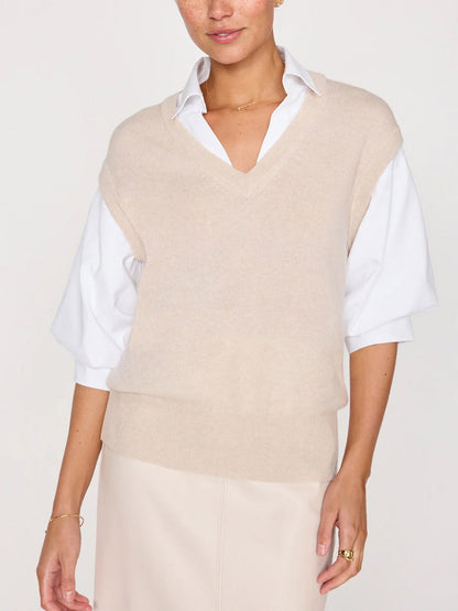 Person wearing an almond buff melange sleeveless V-neck Brochu Walker Kate Shirt Looker Sweater over a white collared shirt, standing against a plain background.