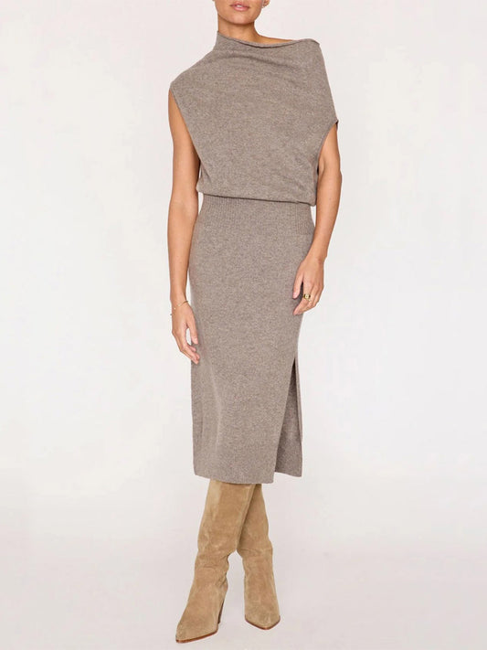 A person wearing a Brochu Walker Lori Sleeveless Dress in Otter Melange paired with tan knee-high suede boots.