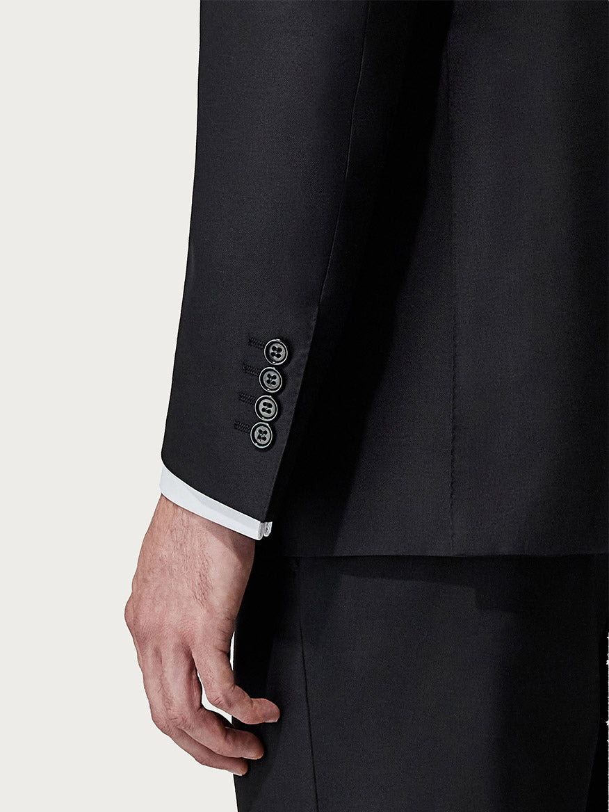 Close-up of a man's arm wearing a Canali Siena Contemporary Black Wool Suit, focusing on the detailed cuff and buttons.