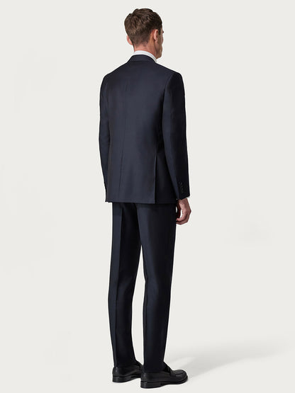 Man in a Canali Siena Contemporary Navy Blue Wool Suit and black shoes viewed from the back, standing against a plain light background.
