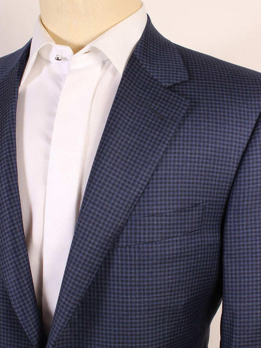 Close-up of a mannequin dressed in a Canali Super 120s Wool Sport Jacket in Classic Blue Check and white shirt with a spread collar.