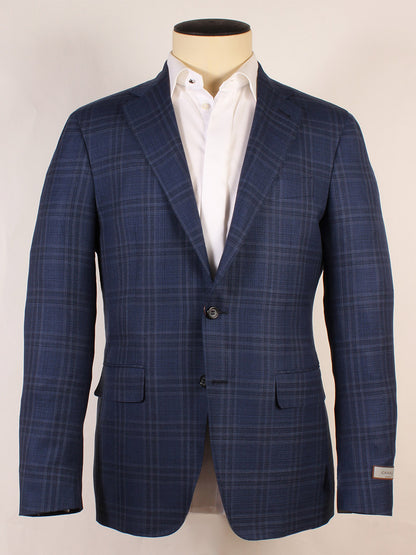 The Canali Kei Flap Pocket Sport Jacket in Navy Windowpane, made in Italy, features two buttons, notch lapels, and flap pockets. Shown on a mannequin with a crisp white dress shirt.
