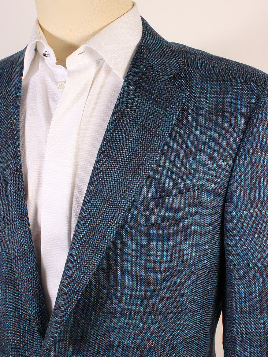 Close-up of a mannequin dressed in a white shirt and a Canali Wool Silk Blend Sport Jacket in Teal/Navy Crossweave Plaid.
